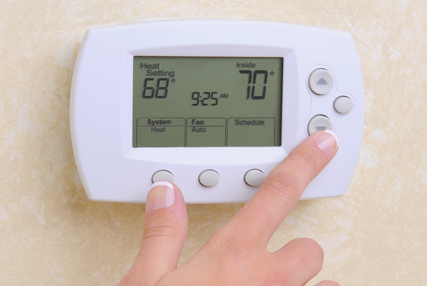 Woman Operating Thermostat